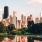pond with city skyline with trees