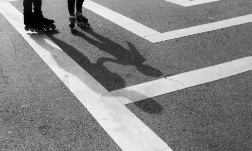 people rollerblading on a road