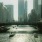 a river with boats in it and tall buildings in the background